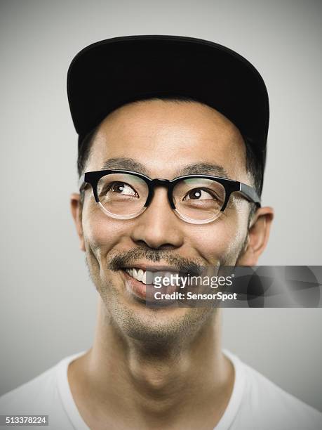 portrait of a young japanese man with big smile - pet stockfoto's en -beelden