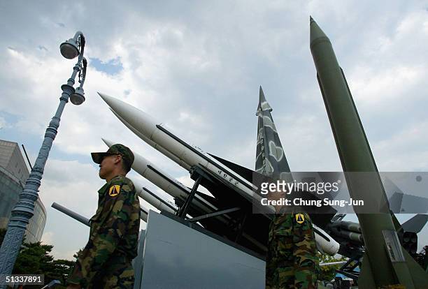 South Korean soldiers walk past scrapped missiles at a war museum on September 23, 2004 in Seoul, South Korea. Japanese government sources have...