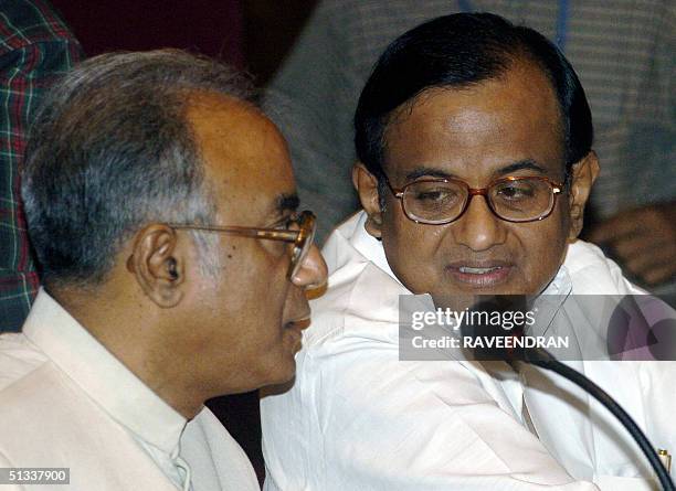 Indian Union Finance Minister P. Chidambaram talks with Indian State of West Bengal's Finance Minister and chairman of the Empowered Committee on...