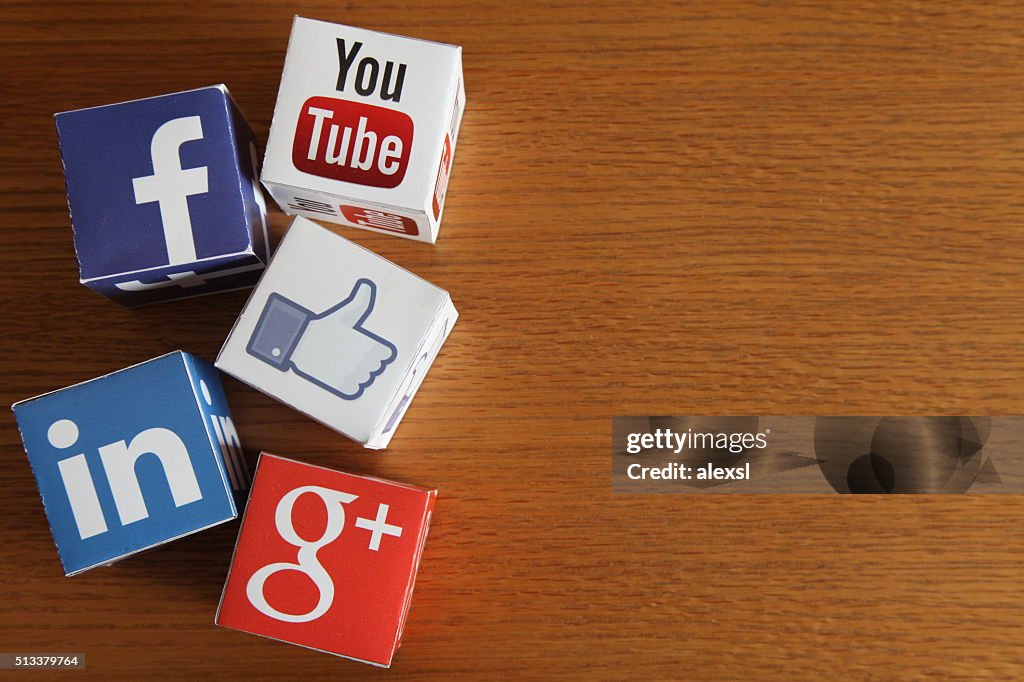 Social media icons cubes on wooden desk background