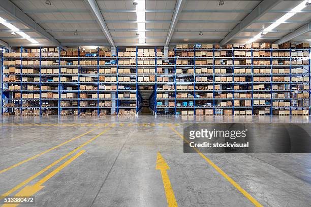 many shelves of cardboard boxes in storehouse - warehouse stock pictures, royalty-free photos & images