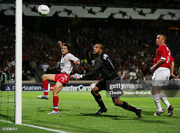 Nilmar Honorata Da Silva of Lyon misses an open goal as Tim Howard and Mikael Silvestre of Mancheter United look on during the UEFA Champions League...