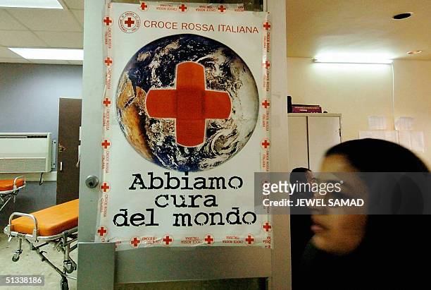 An Iraqi woman enters a makeshift hospital run by the Italian Red Cross in Baghdad, 23 September 2004. Despite security fears, several of medical...