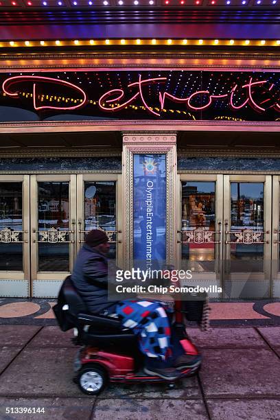 Person wheels past the entrance to the Fox Theater where the Republican presidential candidates will be holding their next debate March 2, 2016 in...