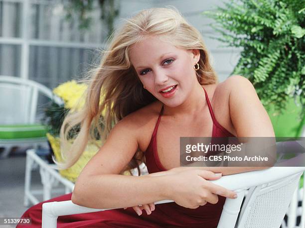 Promotional still from the American television series 'Dallas' shows Charlene Tilton as she leans across the arm of a chair, September 1978.