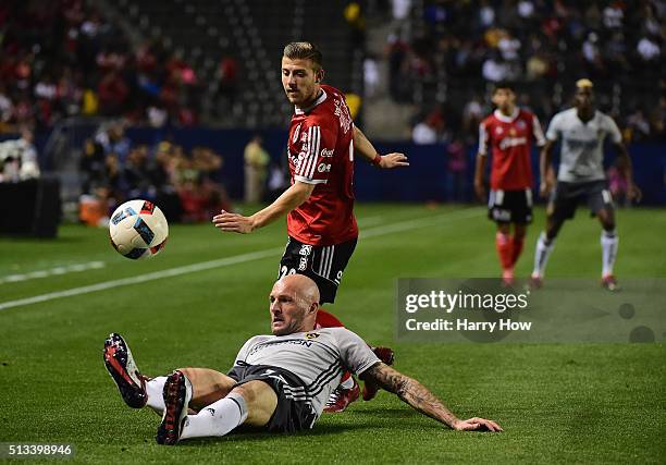 Jelle Van Damme of the Los Angeles Galaxy loses his footing as he defends against Paul Arriola of Club Tijuana during the first half at StubHub...