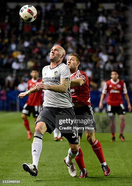 Jelle Van Damme of the Los Angeles Galaxy and Paul Arriola of Club Tijuana chase down a ball during the first half at StubHub Center on February 9,...