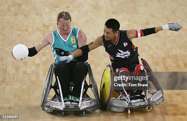 Brad Dubberley of Australia holds off a challenge from Ian Chan of Canada during the Australia v Canada Quartefinal match during the Athens 2004...