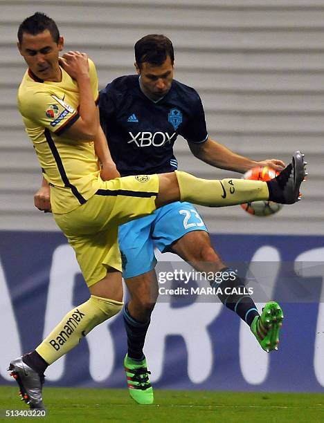 Midfielder Paul Aguilar of Mexican club America vies for the ball with Andreas Ivanschitz of US Seattle Sounders, during their CONCACAF Champions...