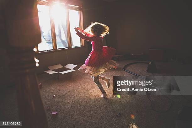 Little Girl Dancing in A sunny Room