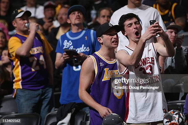 Fans wear an array of jerseys as they attend the game to see Kobe Bryant of the Los Angeles Lakers face the Denver Nuggets in his final game at Pepsi...