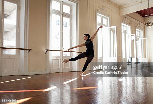 ballerina dancing in beautiful rehearsal room - bailarín fotografías e imágenes de stock