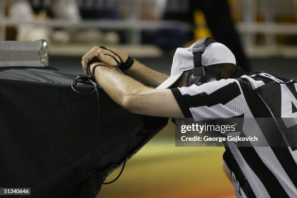 Referee Jeff Triplette reviews a play during the Pittsburgh Steelers 38-3 preseason game win over the Houston Texans on August 21, 2004 at Heinz...