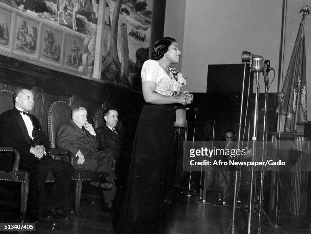 African-American singer Marian Anderson, lawyer and civil rights activist Charles Houston Hamilton and Harold Ickes posing on stage, 1939.