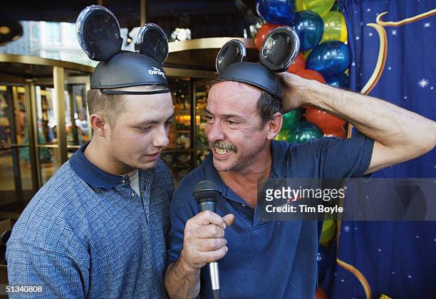 Wearing their Mickey Mouse hats, Shawn Wynn from Puerto Rico and Bennie Henley from New Orleans participate in a Mickey Mouse Club theme singing...