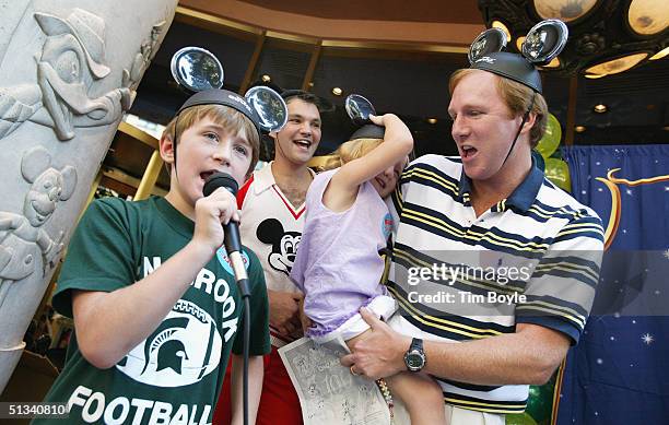 Wearing their Mickey Mouse hats, members of the Cole family from Birmingham, Alabama participate in a Mickey Mouse Club theme singing contest outside...