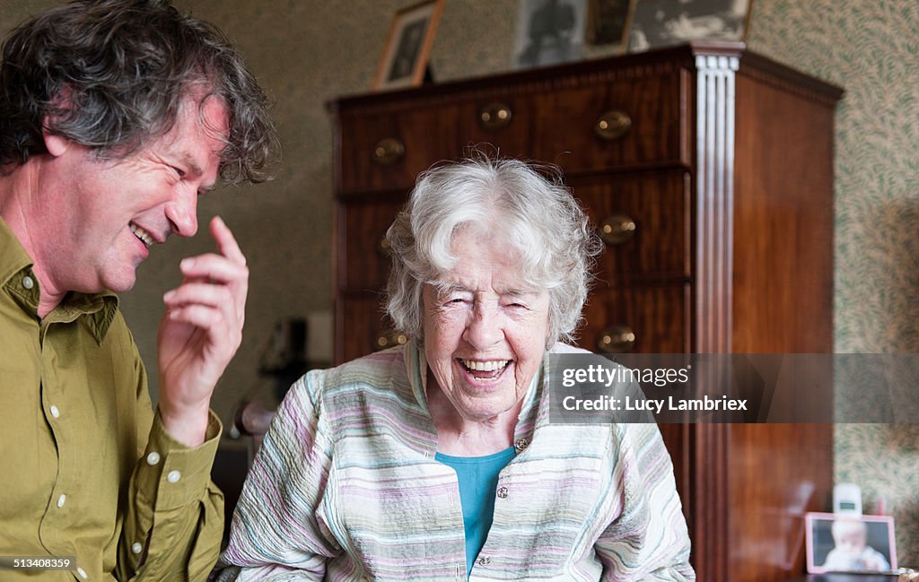 Senior woman and mature man laughing