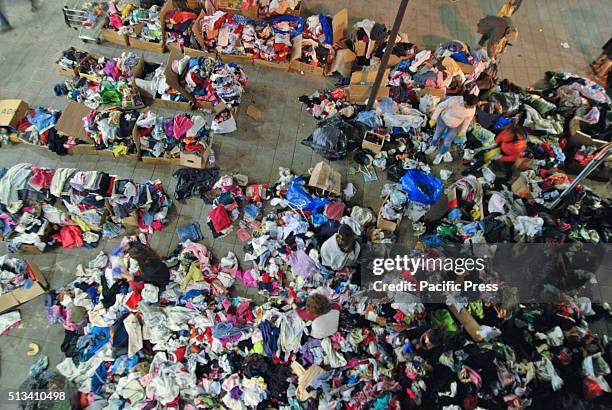 Asylum-seekers at Keleti train station in Budspest select clothing that will fit them from various donors. They are believing that they can go to...