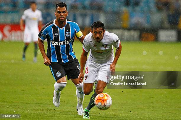 Maicon of Gremio battles for the ball against Fernando Hidalgo of Liga de Quito during the match Gremio v Liga de Quito as part of Copa Bridgestone...