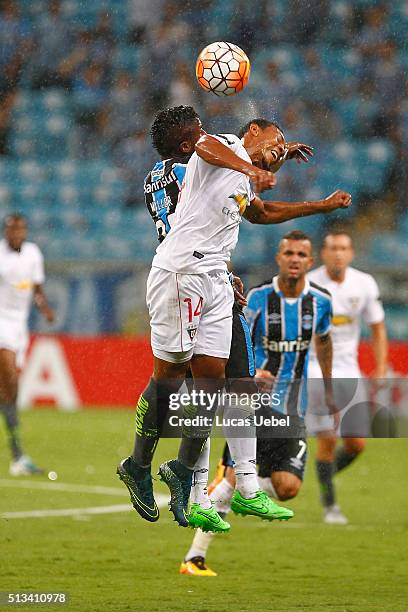 Miler Bolanos of Gremio battles for the ball against Jose Quintero of Liga de Quito during the match Gremio v Liga de Quito as part of Copa...