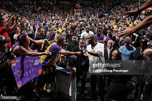 Kobe Bryant of the Los Angeles Lakers passes through a sea of fans as he leaves the court after facing the Denver Nuggets at Pepsi Center on March 2,...