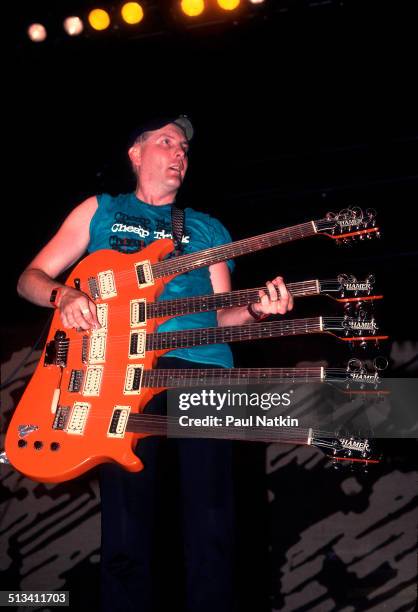 American musician Rick Nielsen plays a five-necked guitar with the band Cheap Trick during a performance onstage, Chicago, Illinois, June 15, 1990.