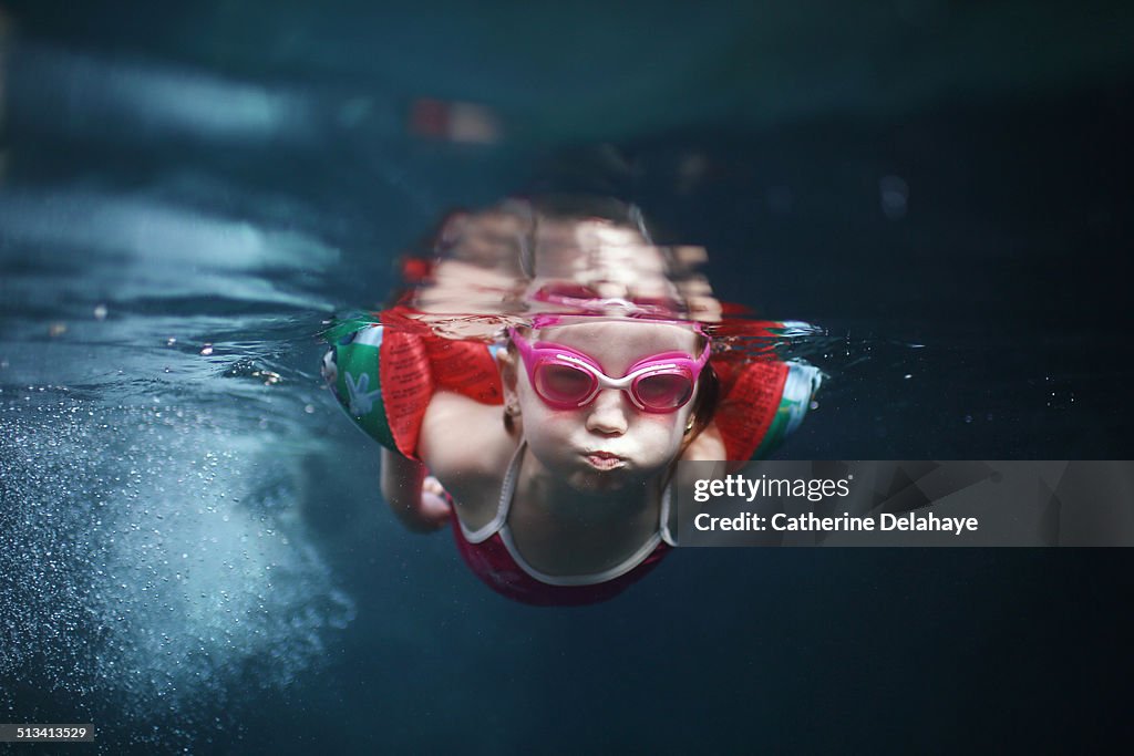 A 4 years old girl swimming under water