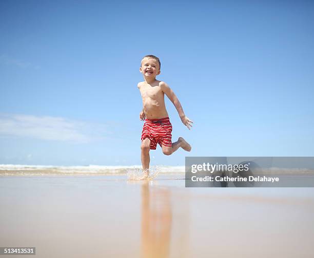 a 3 years boy running on the beach - differential focus stock pictures, royalty-free photos & images