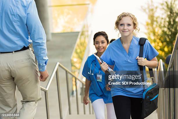 medical or nursing school student walking to class - nurse education stock pictures, royalty-free photos & images