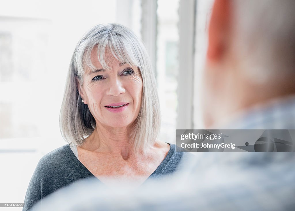 Candid portrait of senior woman with grey bobbed hair