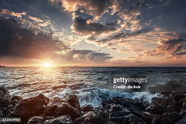 sunset at sea - overcast beach stock pictures, royalty-free photos & images