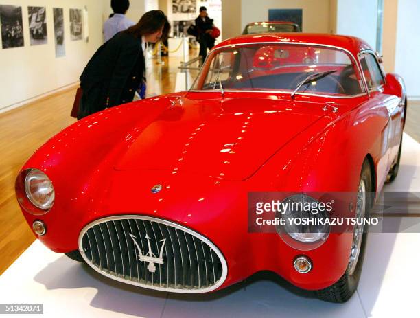 Japanese sportscar fan admires Maserati A6GCS Berlinetta Pininfarina during an exhibition of Italian sports car Ferrari and Maserati at the Tokyo...