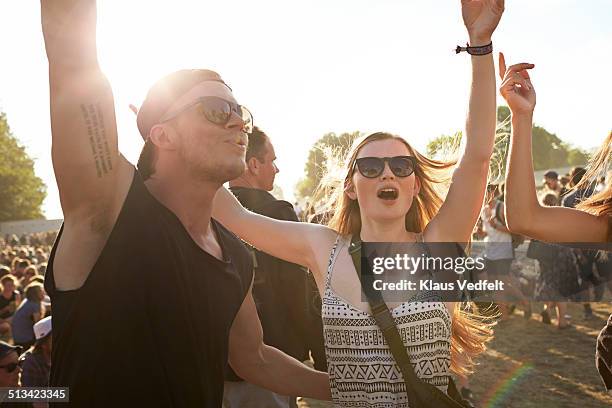 cheerful friends at concert - couple concert photos et images de collection