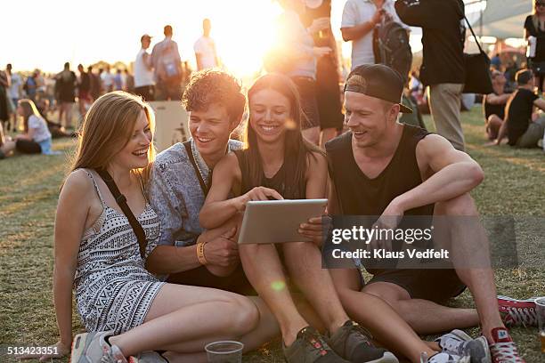 friends looking at tablet & having fun - watching ipad stock pictures, royalty-free photos & images