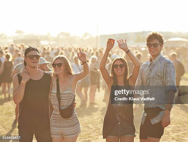 cheerful friends at music festival - popular music concert stock-fotos und bilder