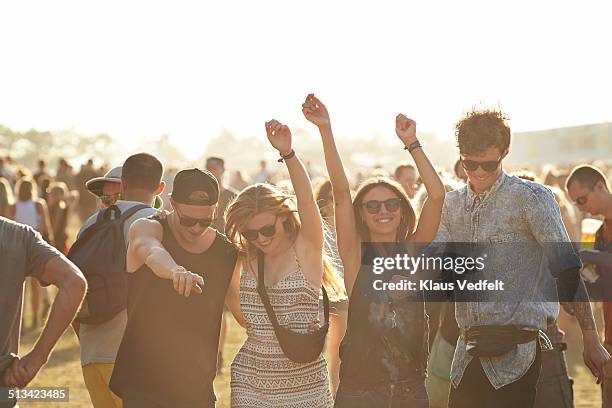 friends dancing at outside concert - fans in the front row stock pictures, royalty-free photos & images