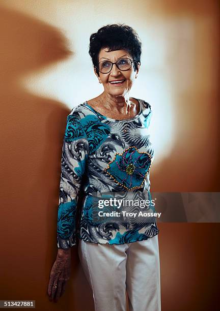 stylish senior leaning against wall. - tempe arizona stock pictures, royalty-free photos & images