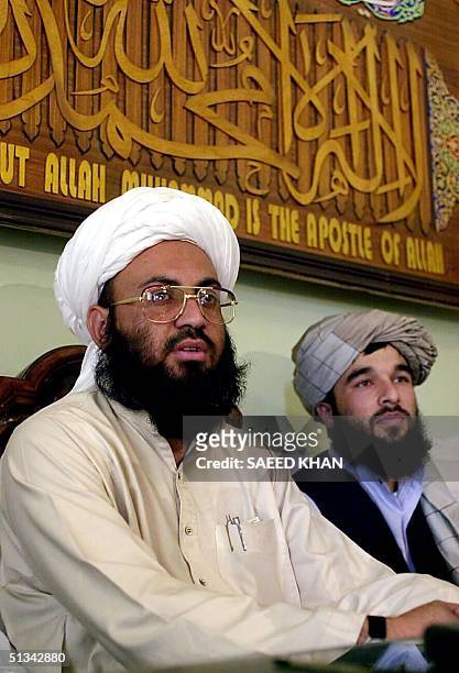 Taliban Foreign Minister Wakil Ahmed Mutawakel sits under an Islamic verse, reading "There is no God but Allah", during a press conference in...