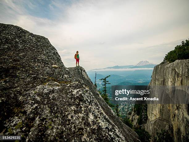 hiker looks off from mountain ridge crest - wilderness stock-fotos und bilder