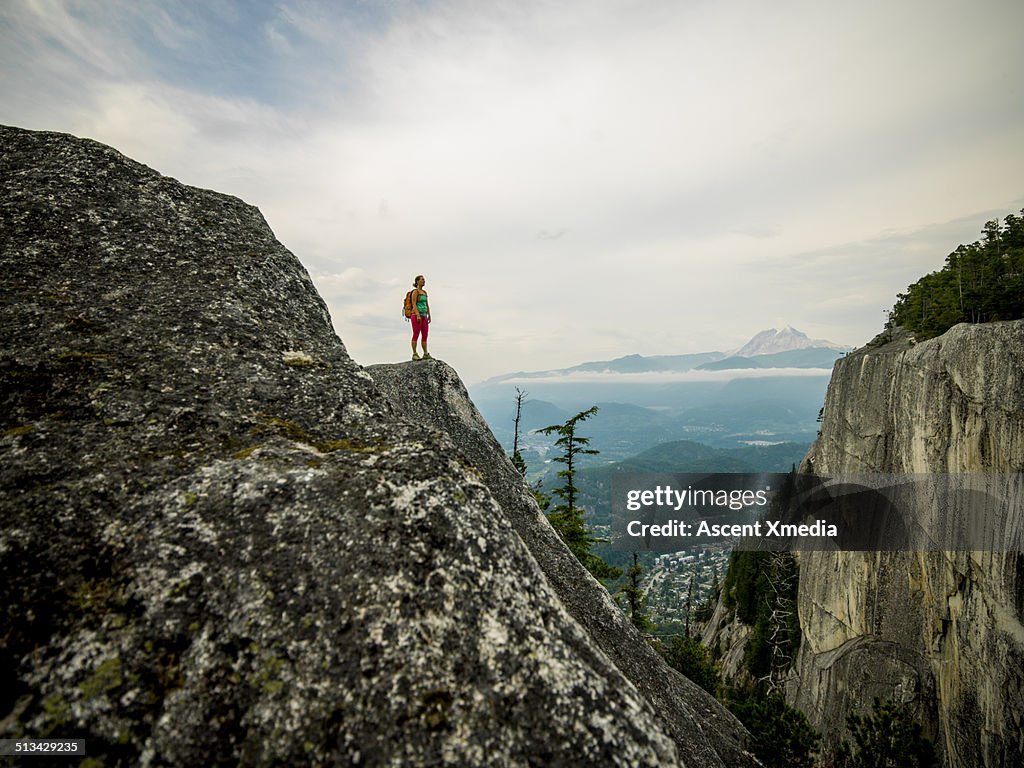 Hiker looks off from mountain ridge crest