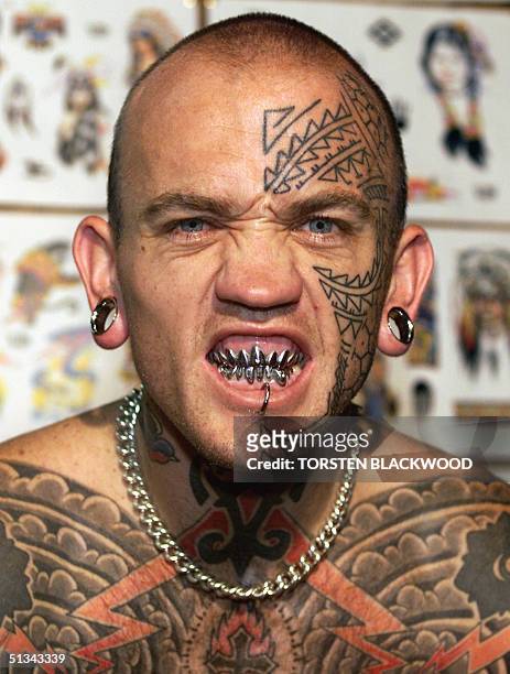 Circus performer Lucky Rich, age 28, shows his stainless steel teeth at the preview of the controversial exhibition of tattooing, piercing and body...