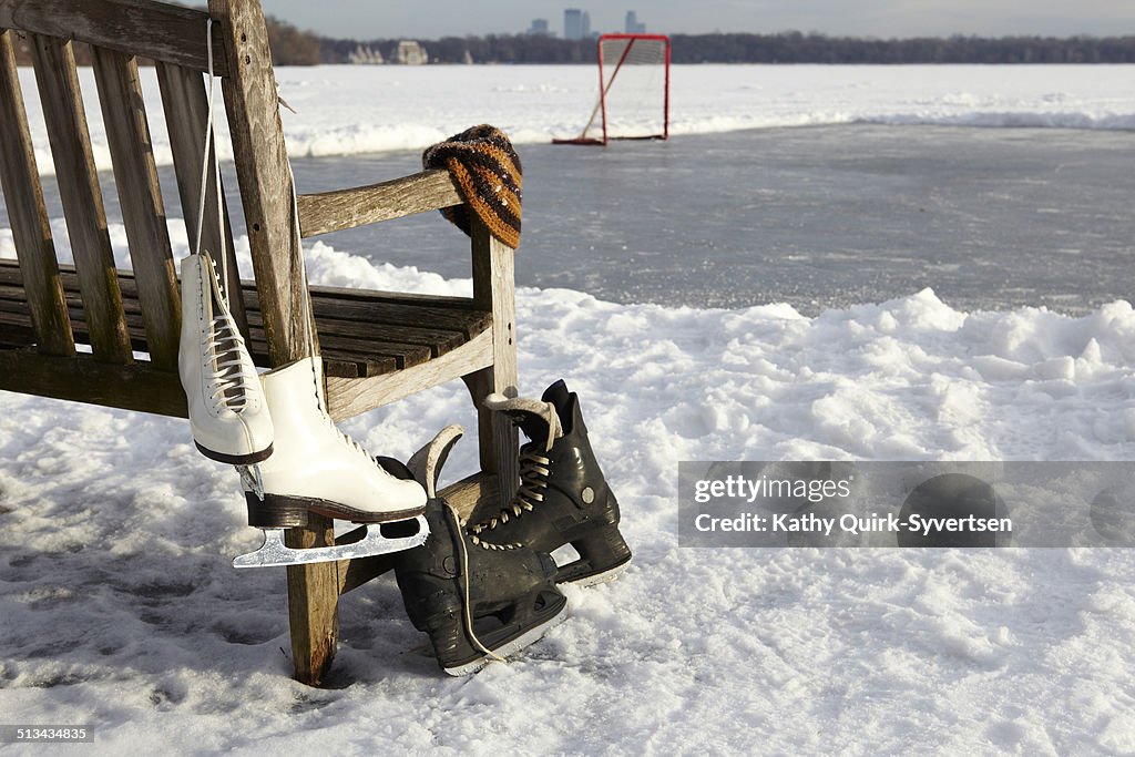 Figure and hockey ice skates on ice rink