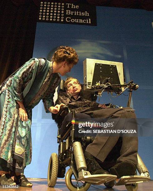 Professor Stephen Hawking,the leading theoretical physicists, attended by his wife Elaine before delivering a lecture on 'Science in the Future' to a...