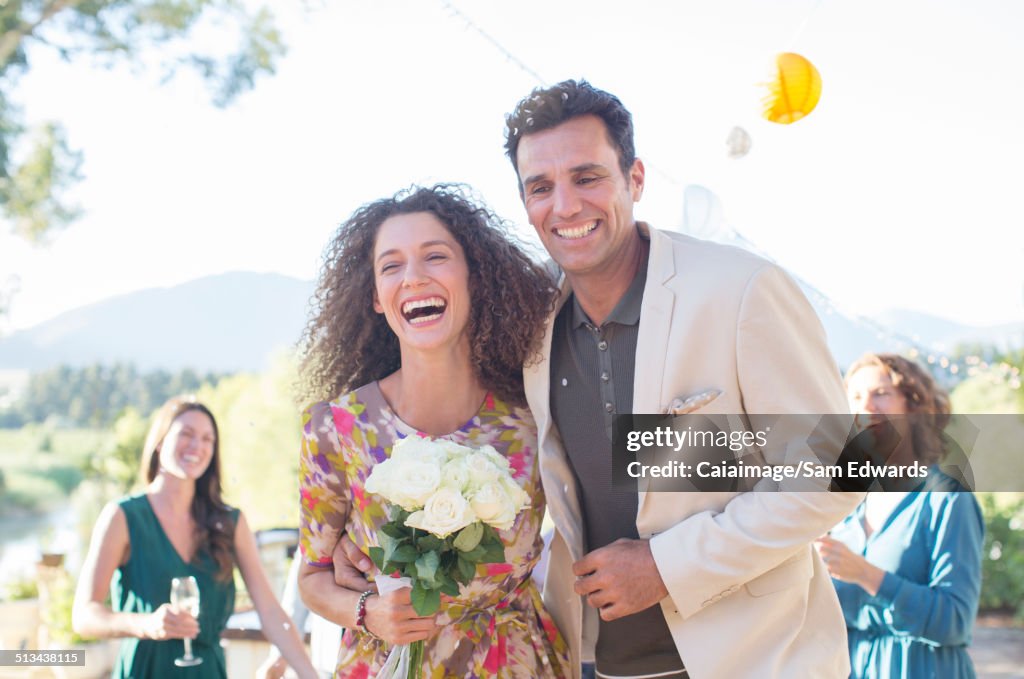 Family throwing rice on newlywed couple