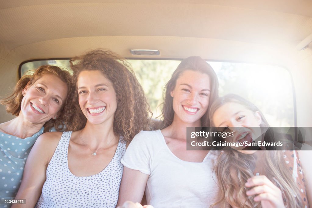 Four women sitting in backseat of car