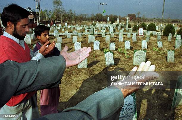 Locals offer burial prayers to the latest martyrs who were buried last week at the Idd-Garh graveyard in Srinagar on 16 November 2000. Since the...