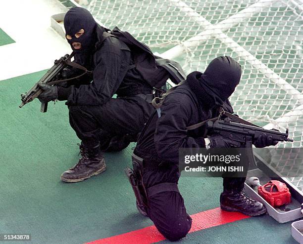 Two Royal Malaysian Marine Police Comandos search for pirates and hostages on board the Japan Coast Guard vessel "PLH SHIKISHIMA" during a...
