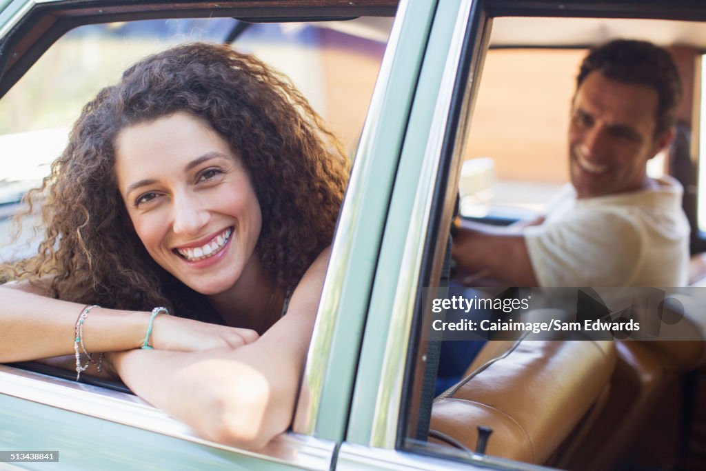 Woman relaxing on car door during car ride