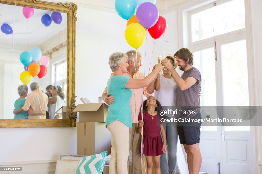 Family celebrating with drinks and balloons