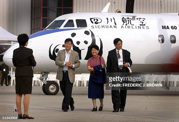 Sichuan Airlines MA-60 turboprop jet, with indigenous panda bears painted on the cockpit exterior, sits on the tarmac at the Airshow China 2000 in...